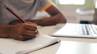 Elève qui prend des notes en classe